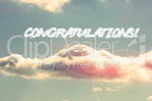 Congratulations! against bright blue sky with cloud