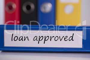 Loan approved on blue business binder