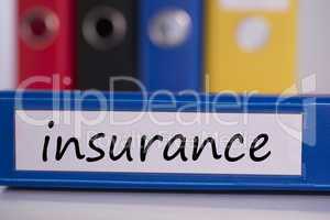 Insurance on blue business binder
