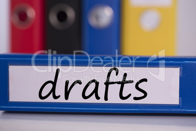 Drafts on blue business binder
