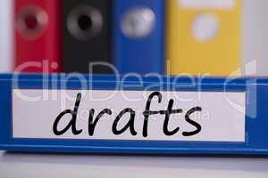 Drafts on blue business binder