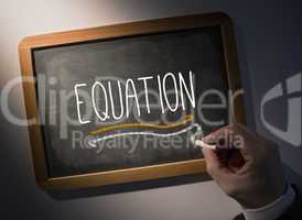 Hand writing Equation on chalkboard