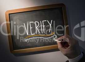 Hand writing Verify on chalkboard