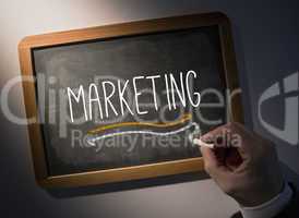 Hand writing Marketing on chalkboard