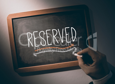 Hand writing Reserved on chalkboard