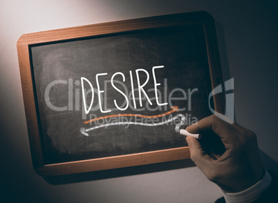 Hand writing Desire on chalkboard