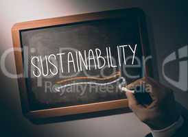 Hand writing Sustainability on chalkboard