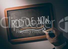 Hand writing Recycle now on chalkboard