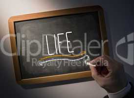 Hand writing Life on chalkboard