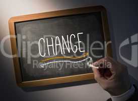 Hand writing Change on chalkboard