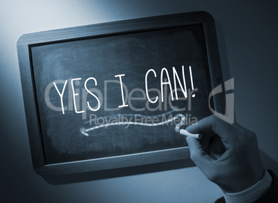 Hand writing Yes i can on chalkboard