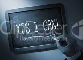 Hand writing Yes i can on chalkboard