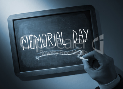 Hand writing Memorial day on chalkboard