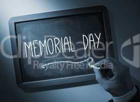 Hand writing Memorial day on chalkboard