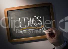 Hand writing Ethics on chalkboard