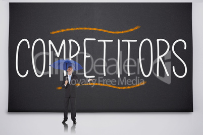 Businessman holding umbrella against the word competitors