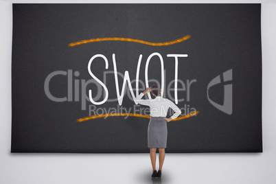 Businesswoman considering the word swot