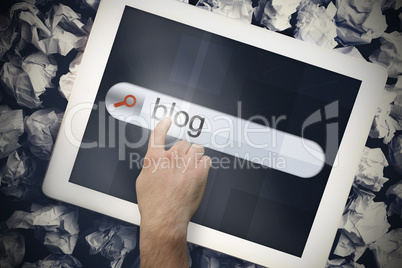 Hand touching blog on search bar on tablet screen