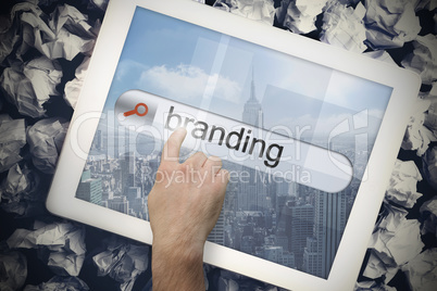 Hand touching branding on search bar on tablet screen