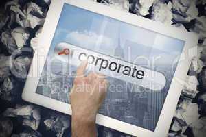 Hand touching corporate on search bar on tablet screen