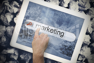 Hand touching marketing on search bar on tablet screen