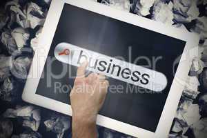 Hand touching business on search bar on tablet screen
