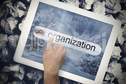 Hand touching organization on search bar on tablet screen