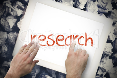 Hand touching research on search bar on tablet screen