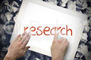 Hand touching research on search bar on tablet screen