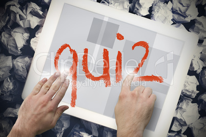 Hand touching quiz on search bar on tablet screen