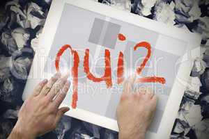 Hand touching quiz on search bar on tablet screen