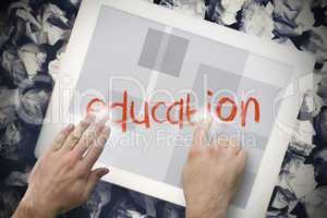 Hand touching education on search bar on tablet screen