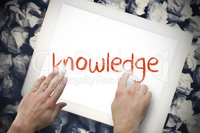Hand touching knowledge on search bar on tablet screen