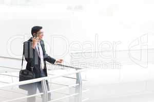 candid indian businessman talking on phone