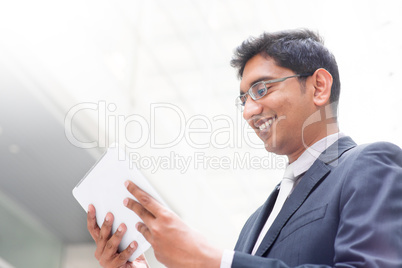 indian businessman using digital tablet pc