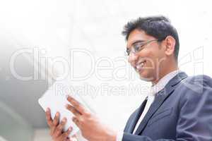 indian businessman using digital tablet pc