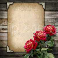 old vintage frame for photos and a bouquet of red roses