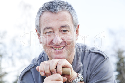 man in the garden draws on spade handle