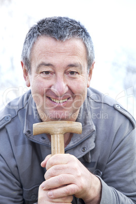 man in the garden draws on spade handle