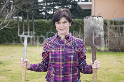 woman with spade and fork in the garden
