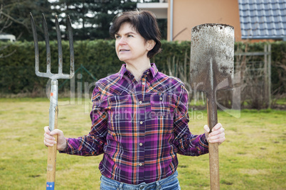 woman with spade and fork in the garden
