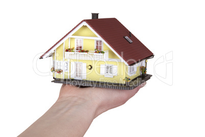 hand holding model house