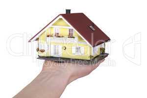 hand holding model house
