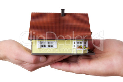 hands of woman and man holding model house