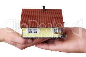 hands of woman and man holding model house