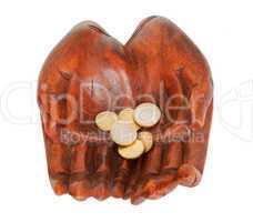 Wooden hands with euro coins