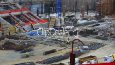 tilt shift construction zone with heavy equipment and workers 2