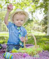 Cute Little Boy Enjoying His Easter Eggs Outside in Park