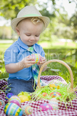 Cute Little Boy Enjoying His Easter Eggs Outside in Park