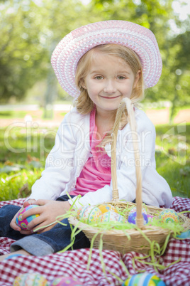 Cute Young Girl Wearing Hat Enjoys Her Easter Eggs